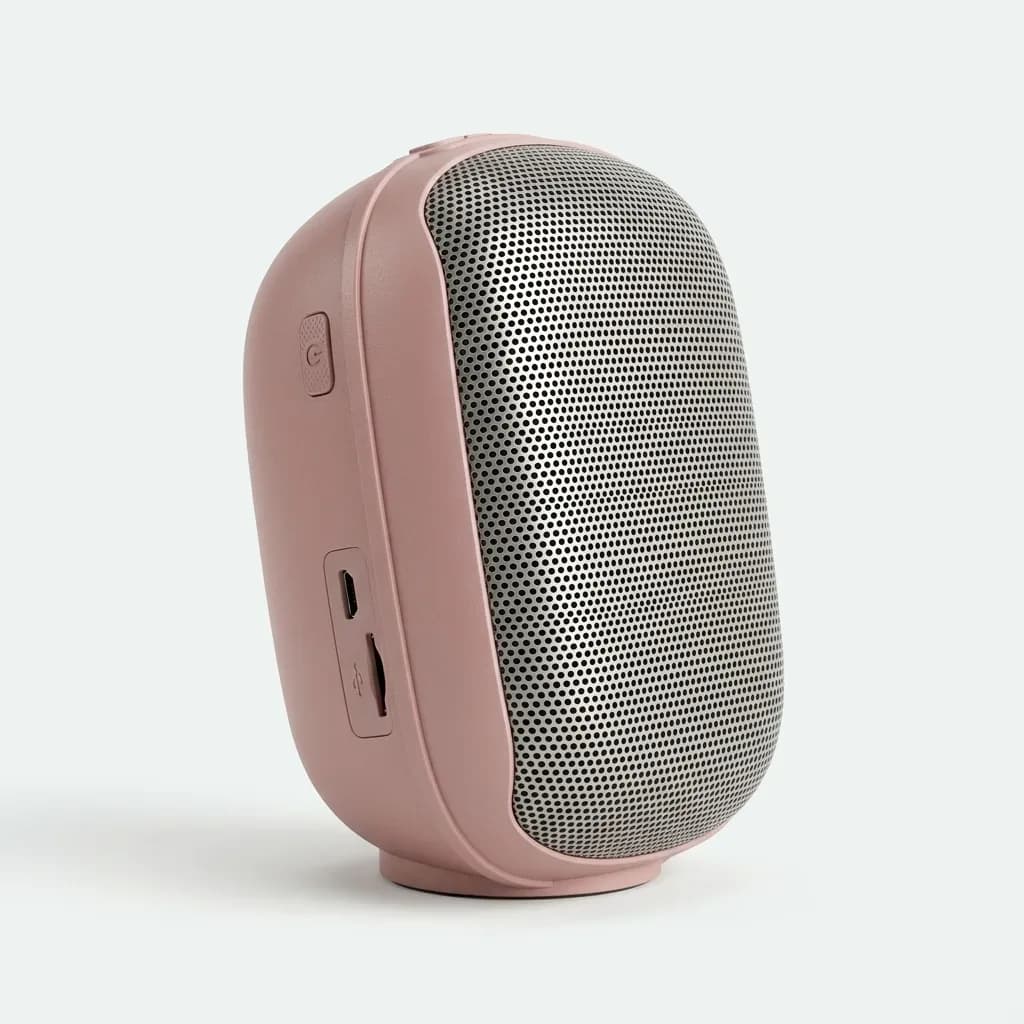 Pink X-530 wireless speaker with front metal grille and side USB and TF card slot area